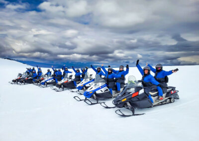 people enjoying a snowmobile ride on Langjökull, the second largest glacier in Europe