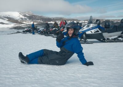 A young woman enjoying a snowmobile ride on Langjökull, the second largest glacier in Europe
